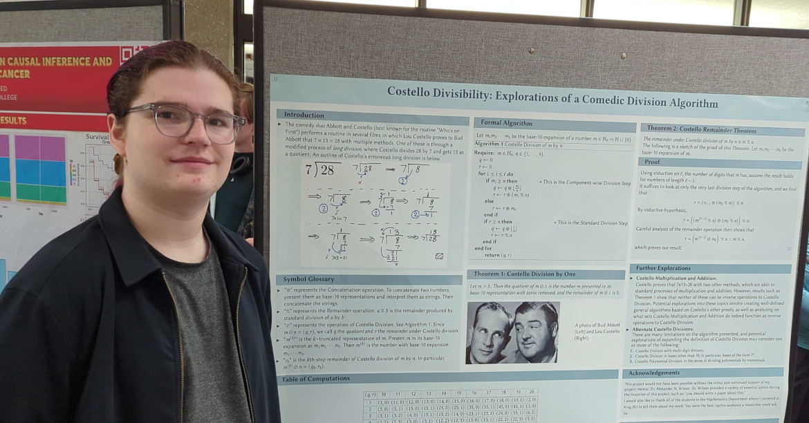 A student standing in front of their poster about a topic called Costello divisibility.